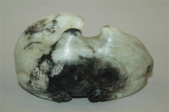 A Chinese white and black jade carving of a recumbent Bactrian camel, in Song dynasty style, 8.5cm